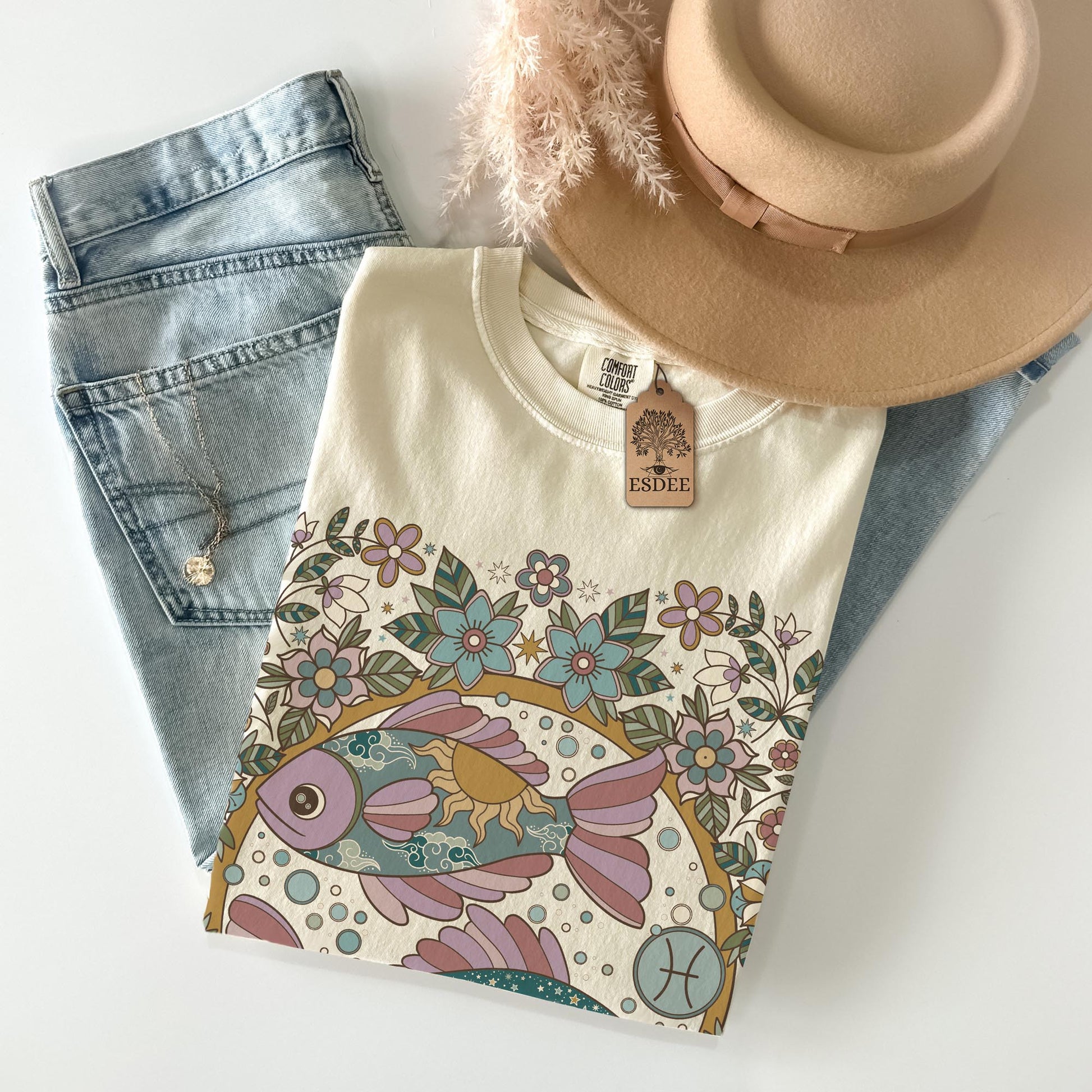 Floral-patterned shirt with denim shorts and a hat on a white background