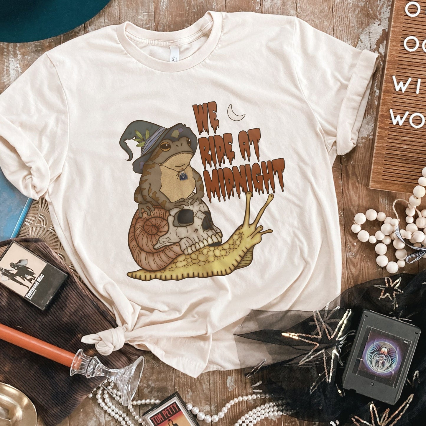 Witchy Swamp Witch Unisex T-Shirt. Frog Riding a Snail. We ride at midnight. Esdee Designs